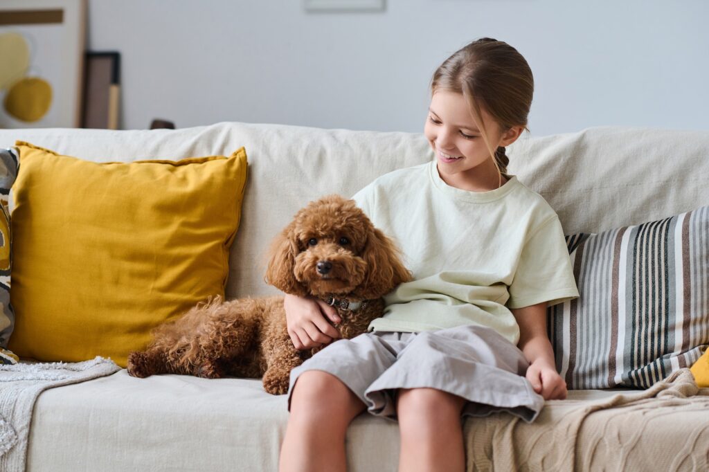 Little girl sitting with her pet at home